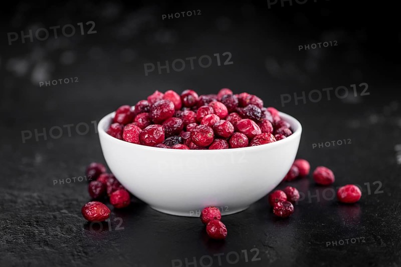 Portion of healthy Dried Cranberries on a slate slab (selective focus)