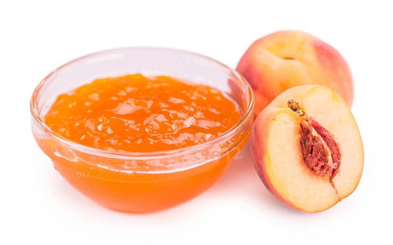 Portion of Peach Jam on a rustic slate slab, selective focus, close-up shot