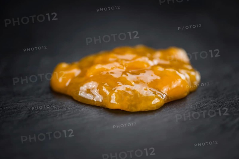Fresh made Apricot Jam on a vintage background (close-up shot)