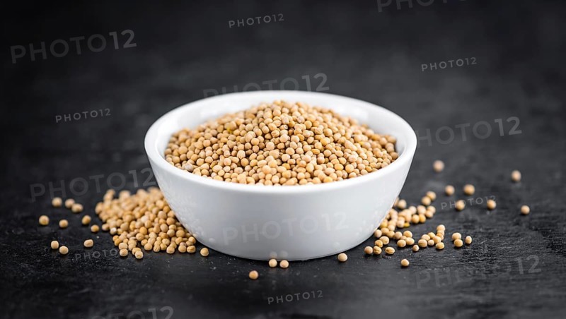 Portion of Seeds (Mustard) on a rustic slate slab (selective focus, close-up shot)