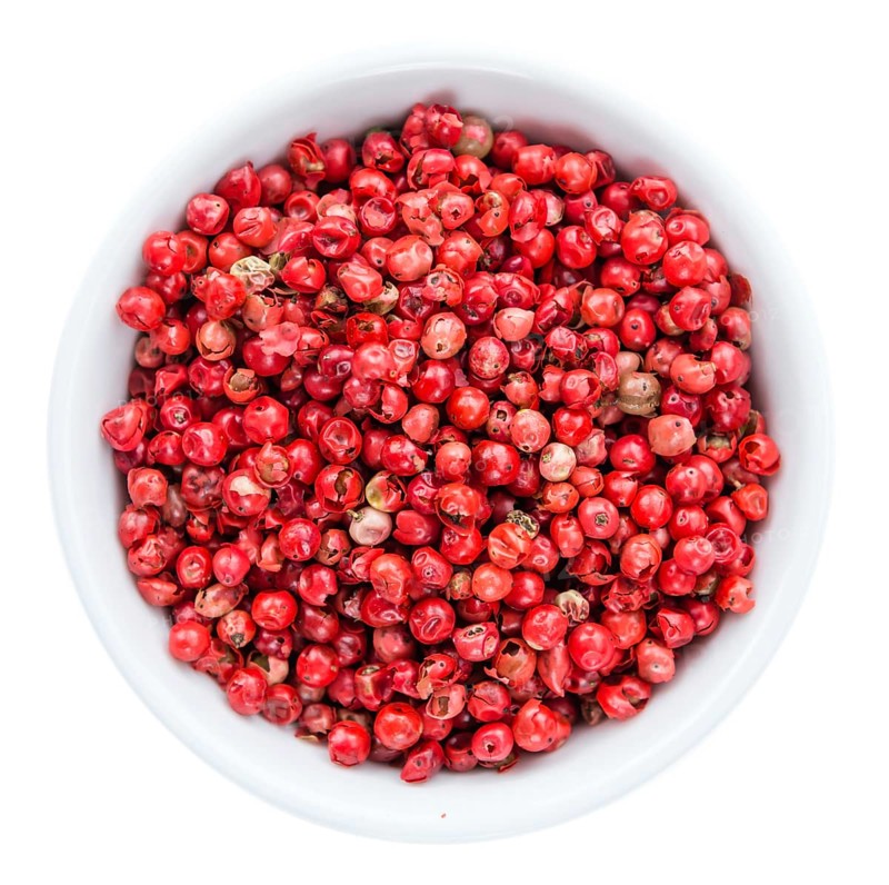 Portion of Pink Peppercorns as detailed close-up shot isolated on white background