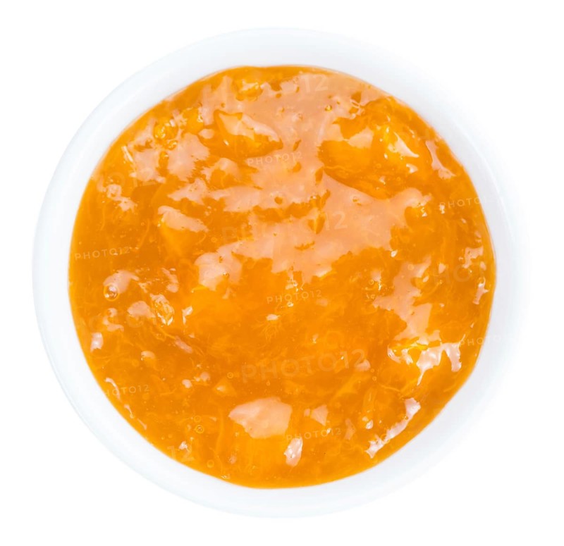 Apricot Jam isolated on white background (selective focus, close-up shot)
