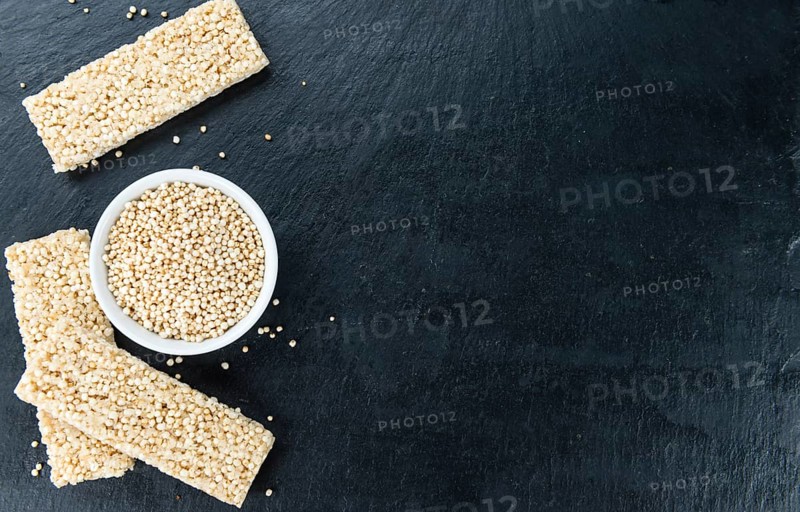 Some Quinoa Bars on a slate slab (close-up shot, selective focus)