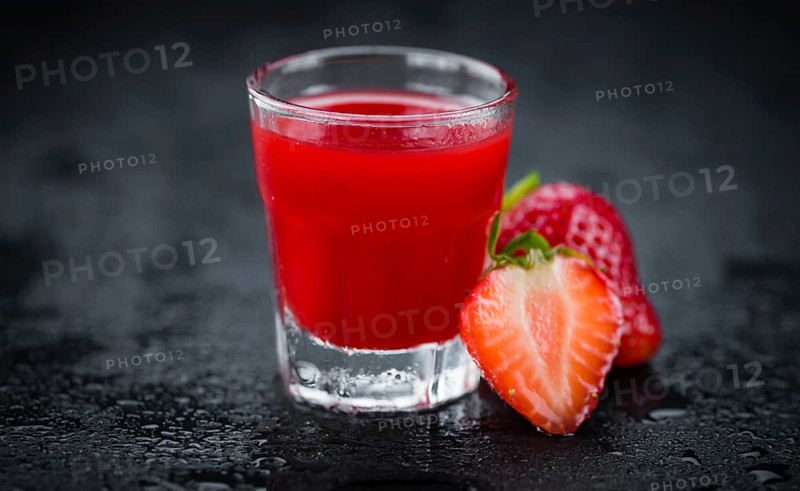 Some homemade Strawberry liqueur as detailed close-up shot, selective focus