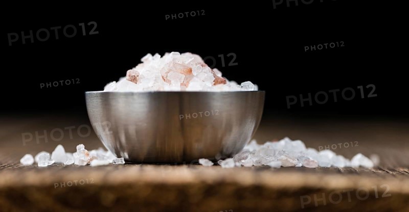 Pink Salt on a vintage background as detailed close-up shot (selective focus)