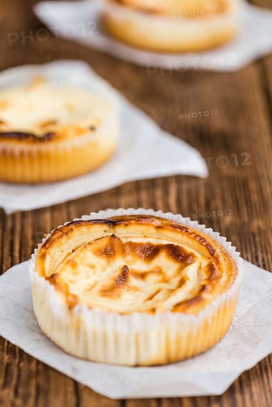 Fresh made Mini Cheesecake on an old and rustic wooden table (selective focus, close-up shot)