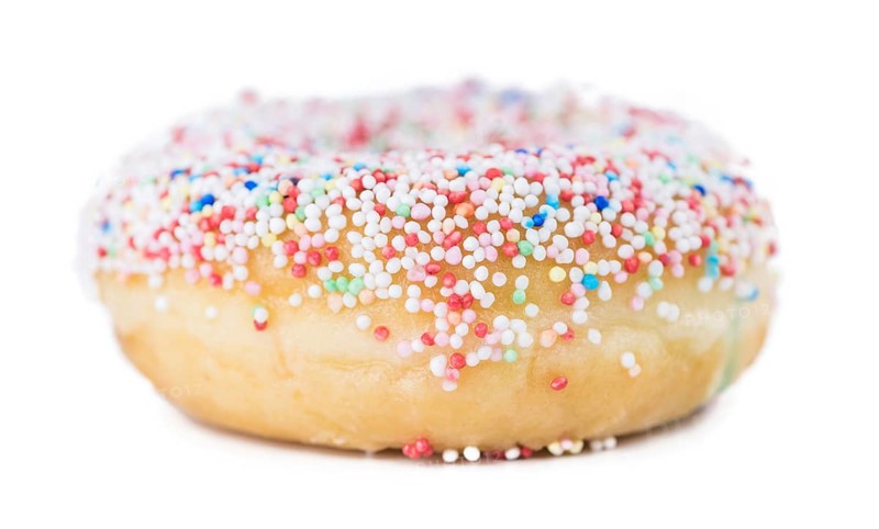 Some fresh made Donuts isolated on white background (close-up shot)
