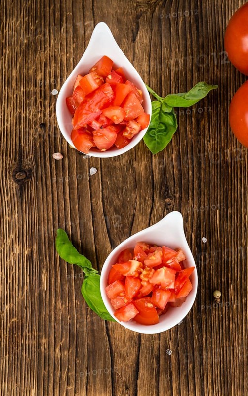 Diced Tomatoes on a vintage background as detailed close-up shot (selective focus)