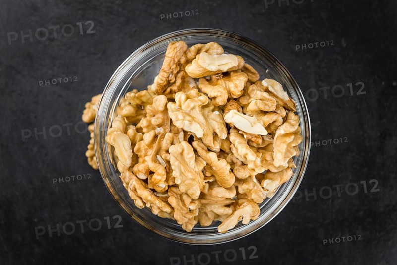Walnut kernels on a vintage background as detailed close-up shot (selective focus)