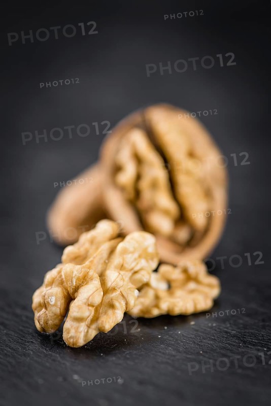 Walnut kernels on a vintage background as detailed close-up shot (selective focus)