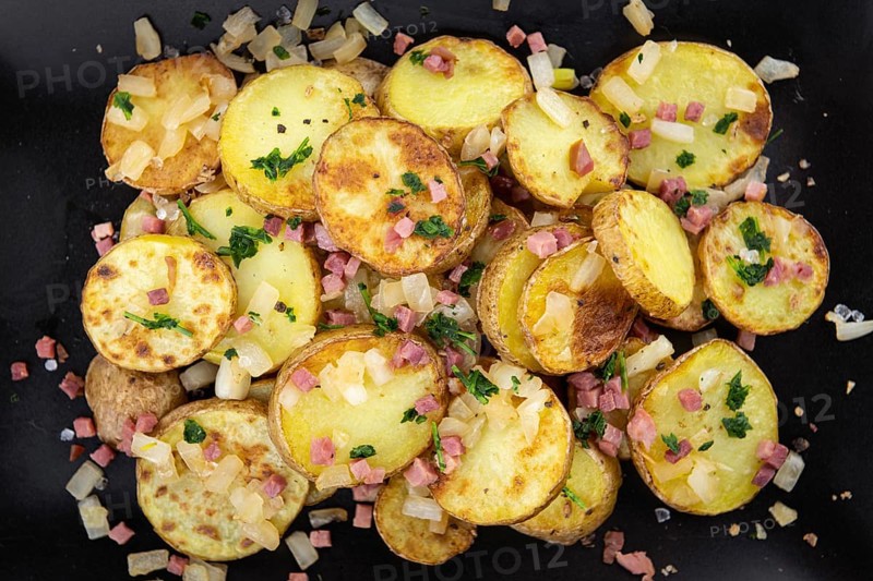 Portion of fresh homemade Fried Potatoes on an old wooden table (selective focus, close-up)