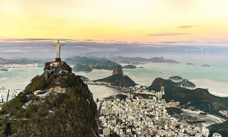 Cristo Redentor statue in Rio de Janeiro (aerial shot made from a helicopter) during a spectacular sunset