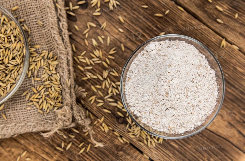 Portion of fresh Oat Flour on an old wooden table