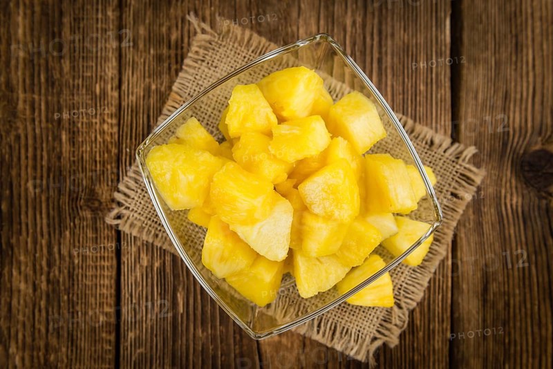 Fresh made Pineapple (sliced) on a vintage background as detailed close-up shot