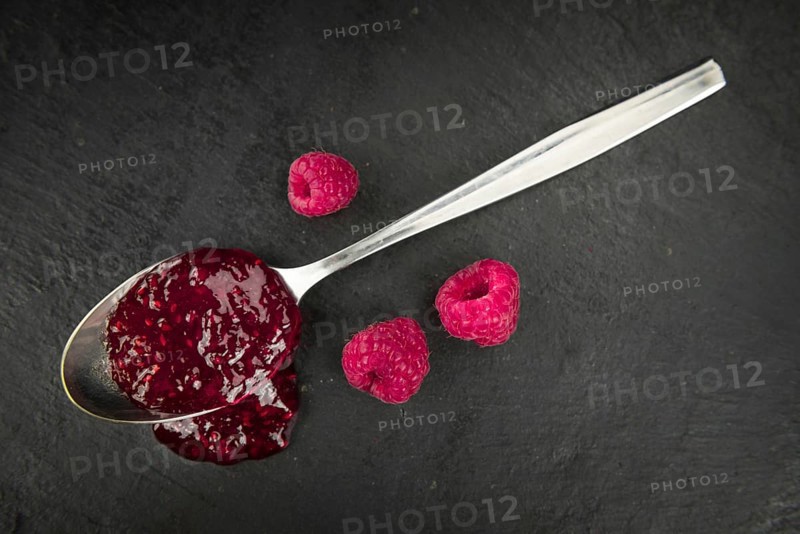 Some Raspberry Jam on a slate slab as detailed close-up shot, selective focus