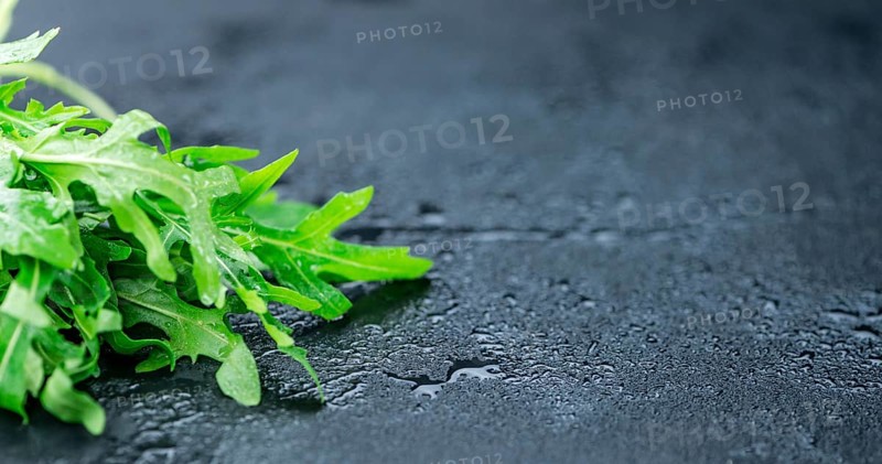 Portion of fresh Arugula (detailed close-up shot, selective focus)