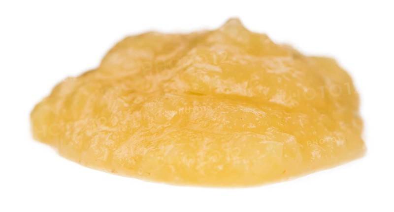 Homemade Applesauce (selective focus) isolated on white background (close-up shot)