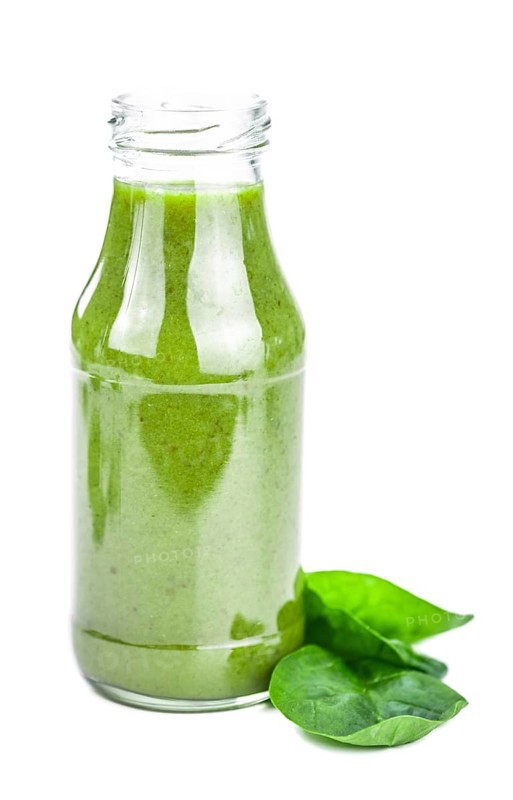 Homemade spinach smoothie isolated on white background (close up, selective focus)