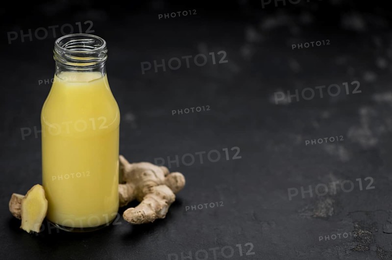 Portion of healthy Ginger Drink (selective focus, close-up shot)
