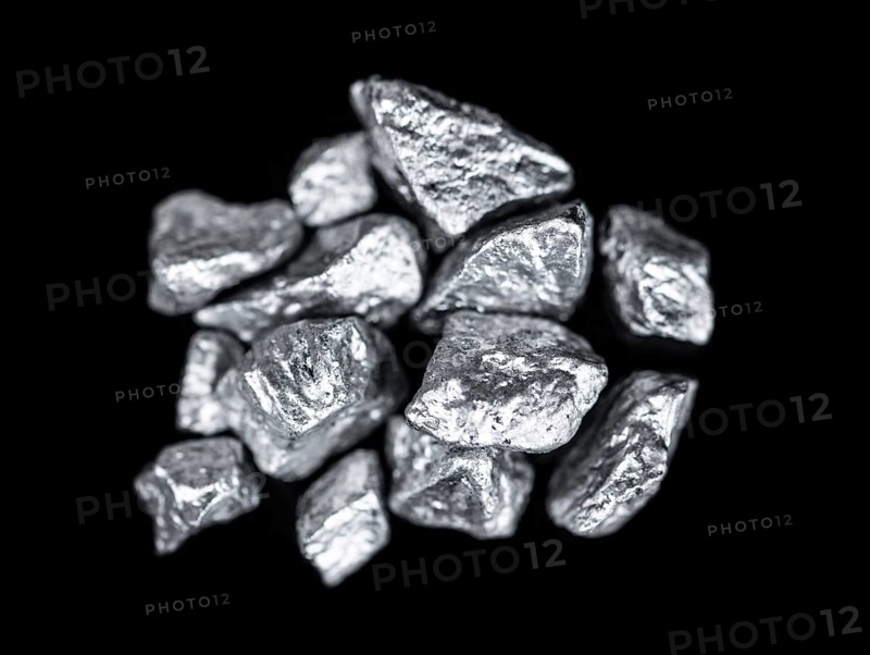 Heap of silver nuggets isolated on black background (close up)