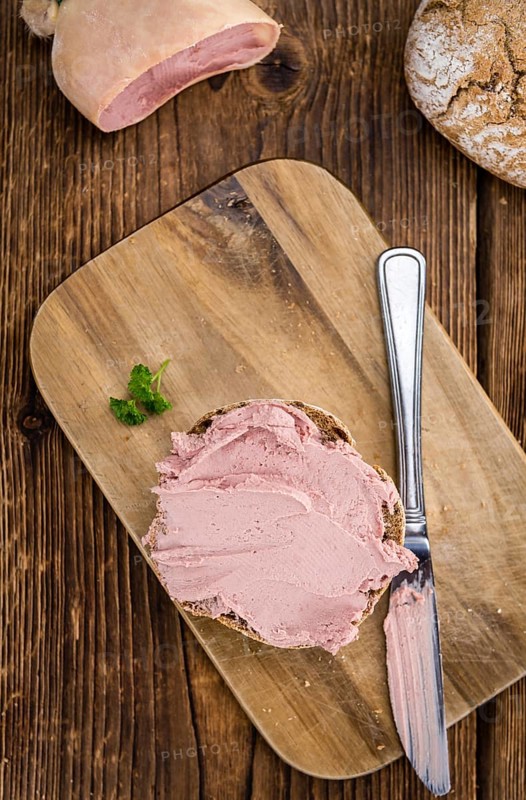 Homemade Liverwurst Sandwich on an wooden table (selective focus) as detailed close-up shot