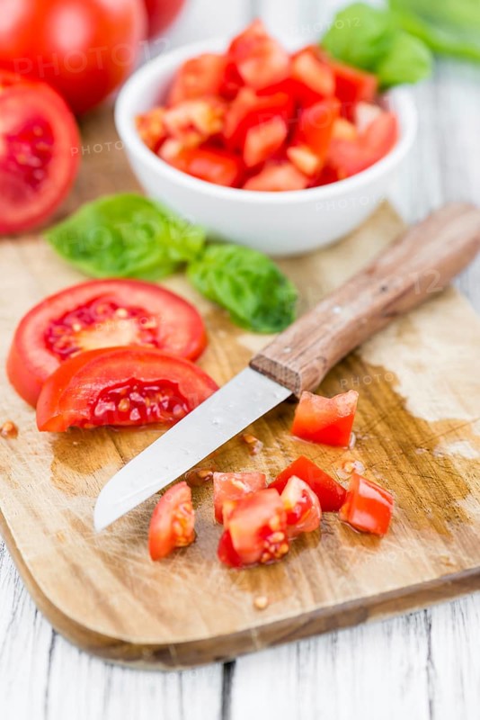 Diced Tomatoes on a vintage background as detailed close-up shot (selective focus)