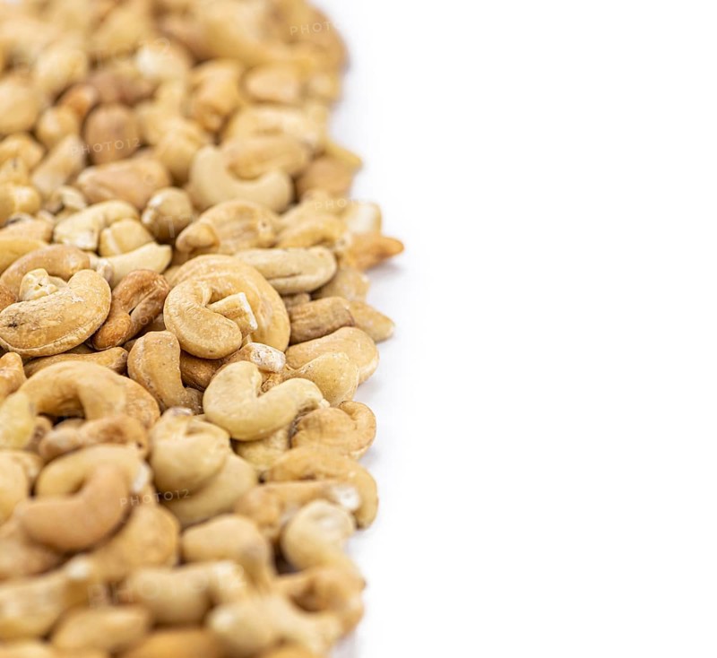 Cashew Nuts isolated on white background (close up shot, selective focus)