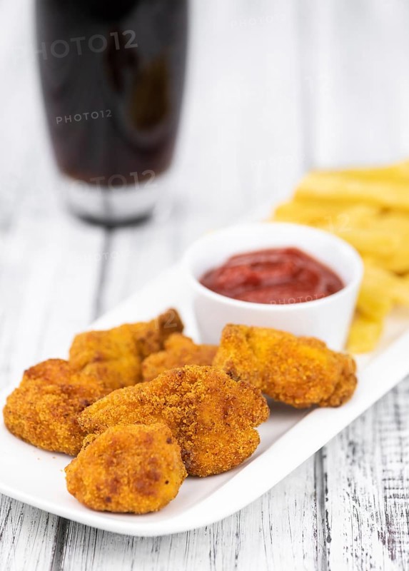 Homemade Chicken Nuggets on vintage background (selective focus, close-up shot)