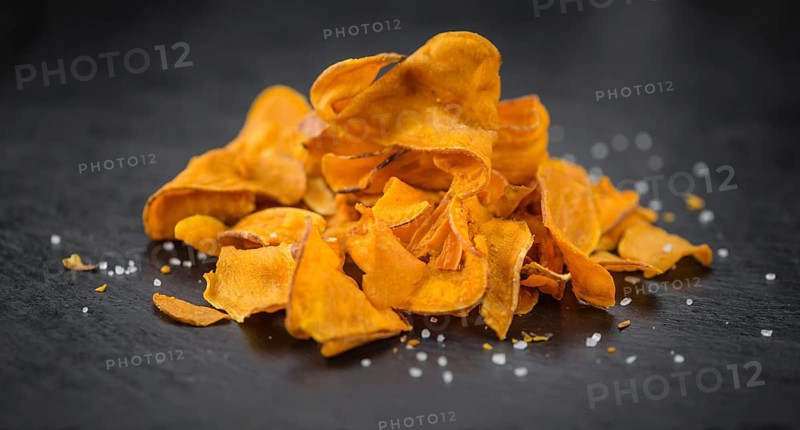 Some fresh Sweet Potato Chips on a vintage slate slab, selective focus, close-up shot