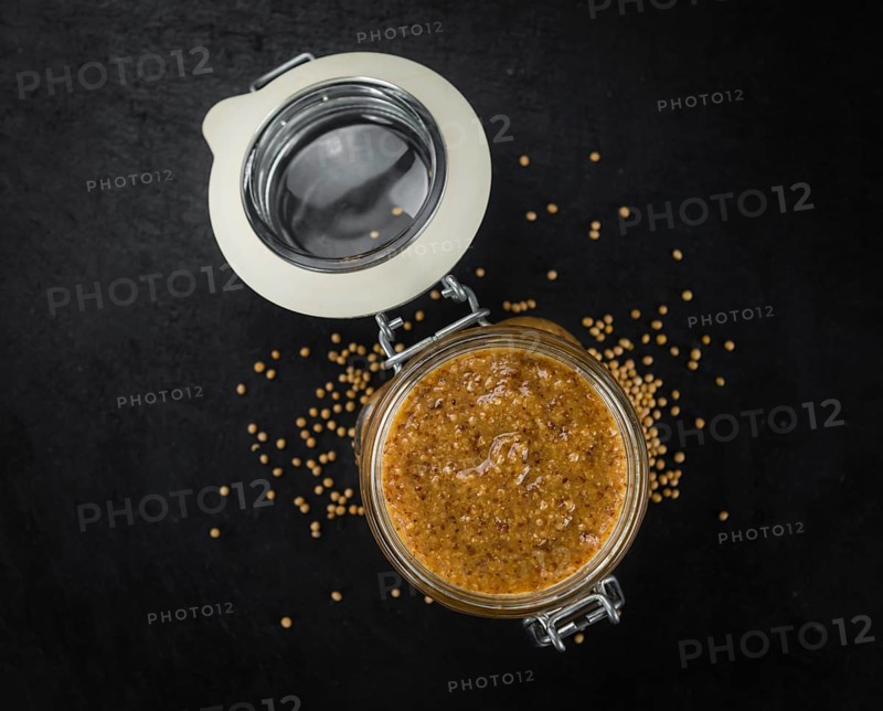 Fresh made German Cuisine (sweet Mustard) on a vintage background (close-up shot)