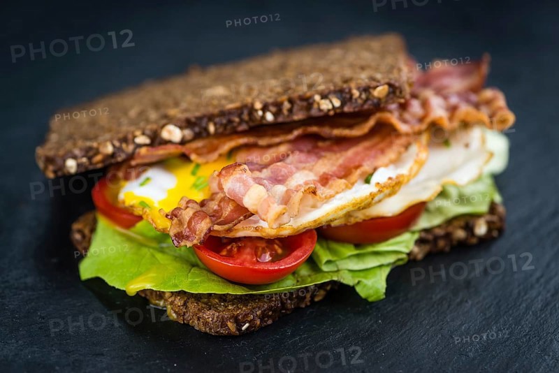 Slate slab with a Bacon and Egg Sandwich (close-up shot)