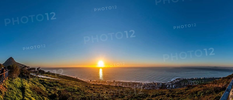 Tourists watching the sunset from Signal Hill, Cape Town South Africa during winter season