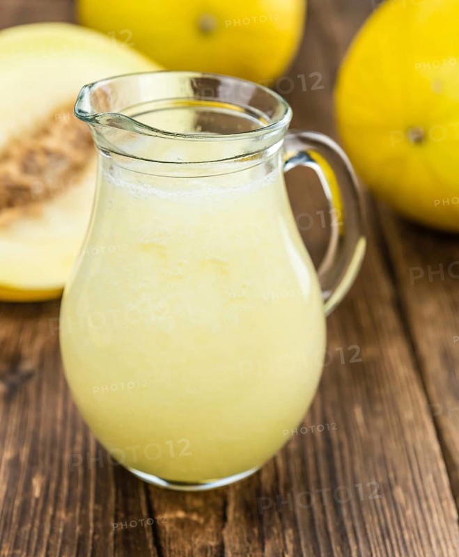 Homemade Honeydew Melon Smoothie on wooden background (selective focus)