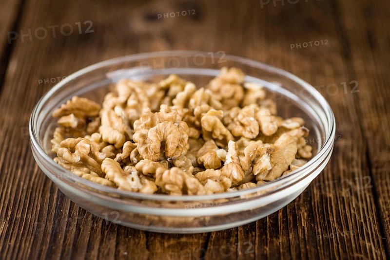 Walnut kernels on a vintage background as detailed close-up shot (selective focus)