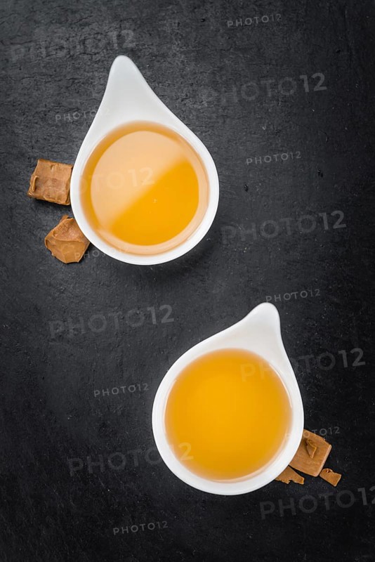 Syrup (Caramel taste) on a vintage slate slab (close-up shot, selective focus)
