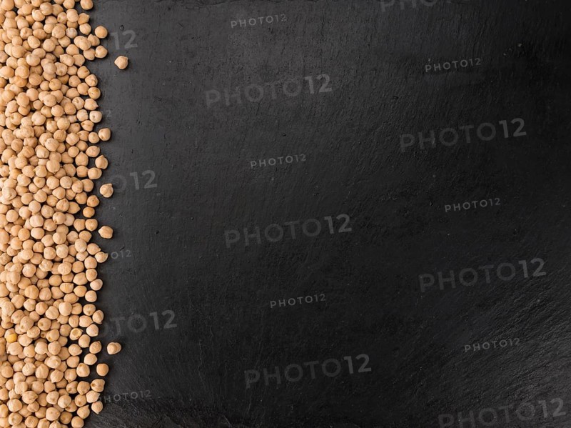 Portion of dried Chickpeas on a rustic slate slab, selective focus, close-up shot