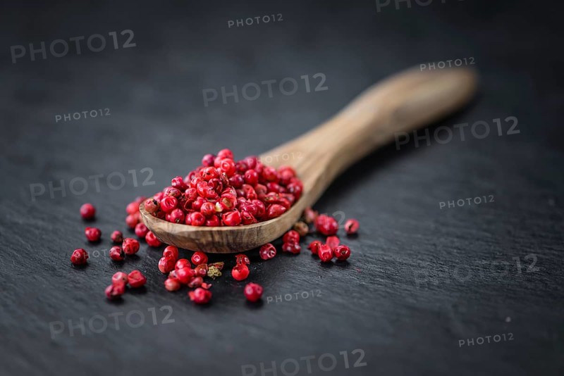 Pink Peppercorns on a vintage background as detailed close-up shot, selective focus