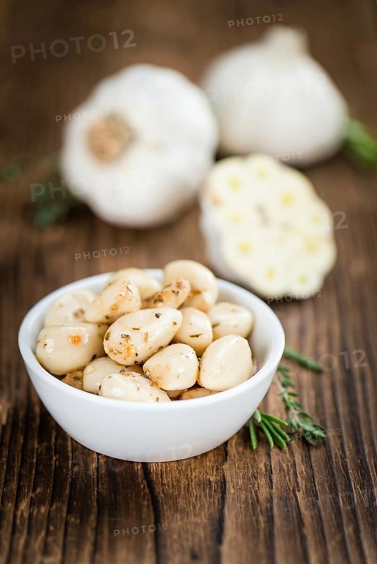 Portion of fresh Preserved Garlic (close-up shot, selective focus)