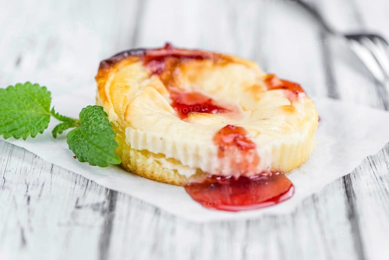 Cheesecake with berry Sacue on a vintage background as detailed close-up shot (selective focus)