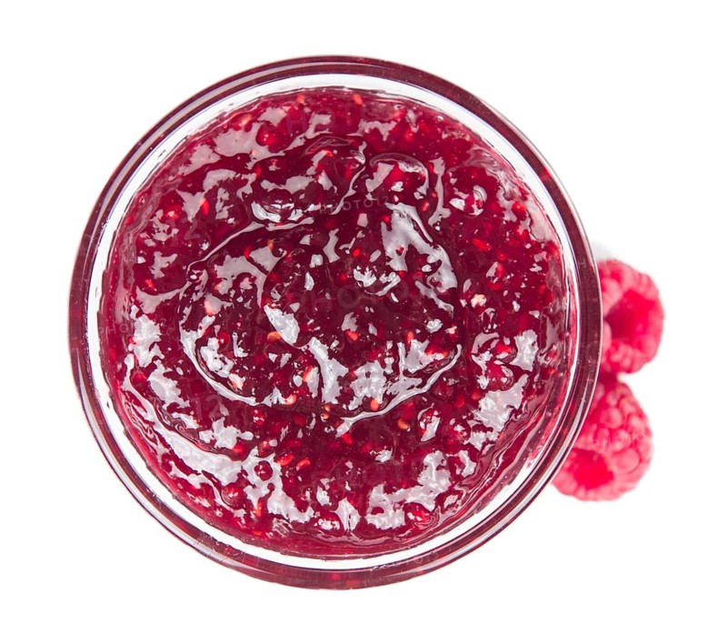 Fresh made Raspberry Jam isolated on white background, close-up shot