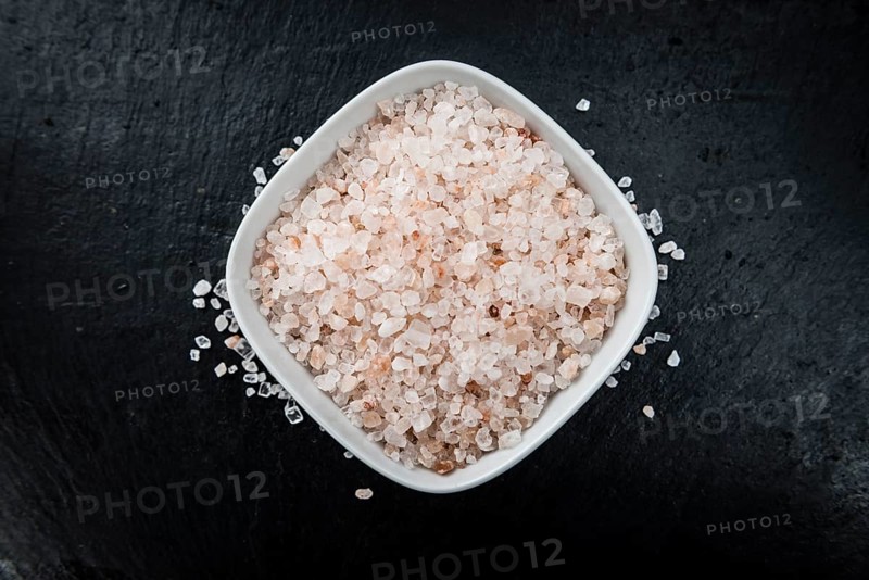 Portion of Himalayan Salt on a rustic slate slab (selective focus, close-up shot)