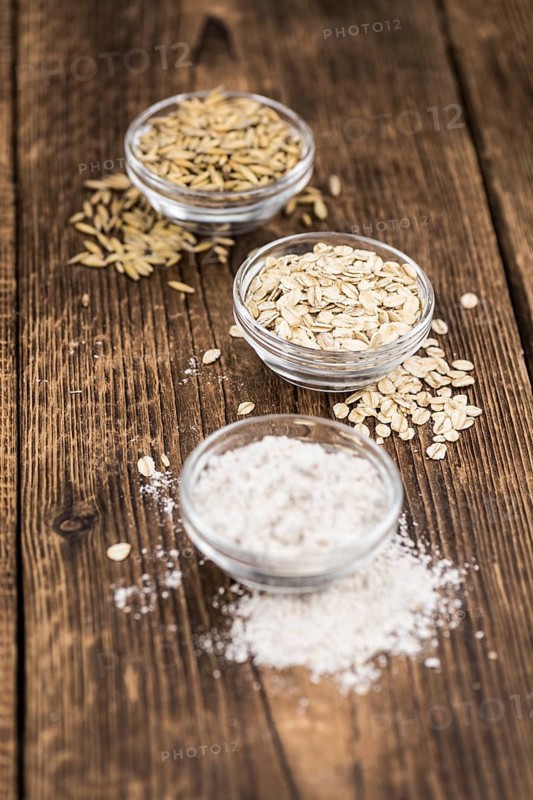 Some Oat Flour on a vintage wooden table (selective focus, close-up shot)