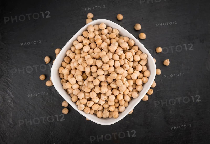 Portion of dried Chickpeas on a rustic slate slab, selective focus, close-up shot