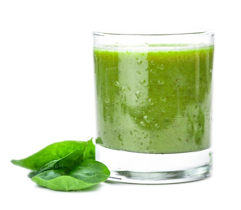 Homemade spinach smoothie isolated on white background (close up, selective focus)
