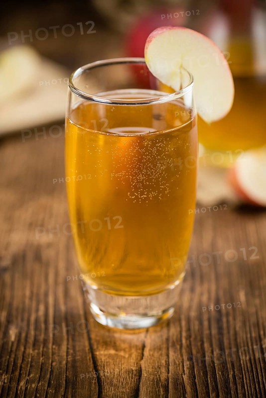 Fresh made Apple Cider on a vintage background (close-up shot)