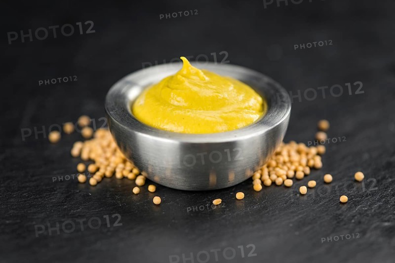 Mustard on a vintage background as detailed close-up shot (selective focus)