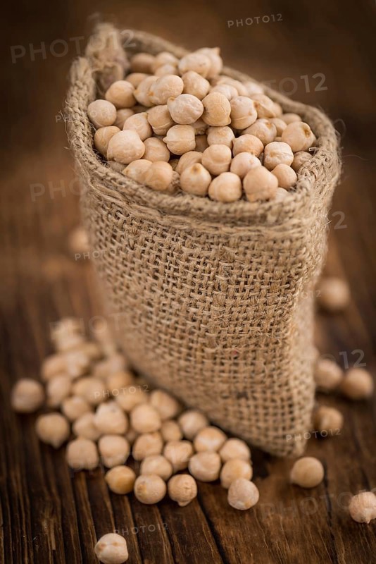 Chickpeas on a vintage background as detailed close-up shot, selective focus