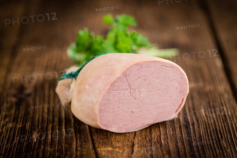 Liverwurst on a vintage background as detailed close-up shot (selective focus)