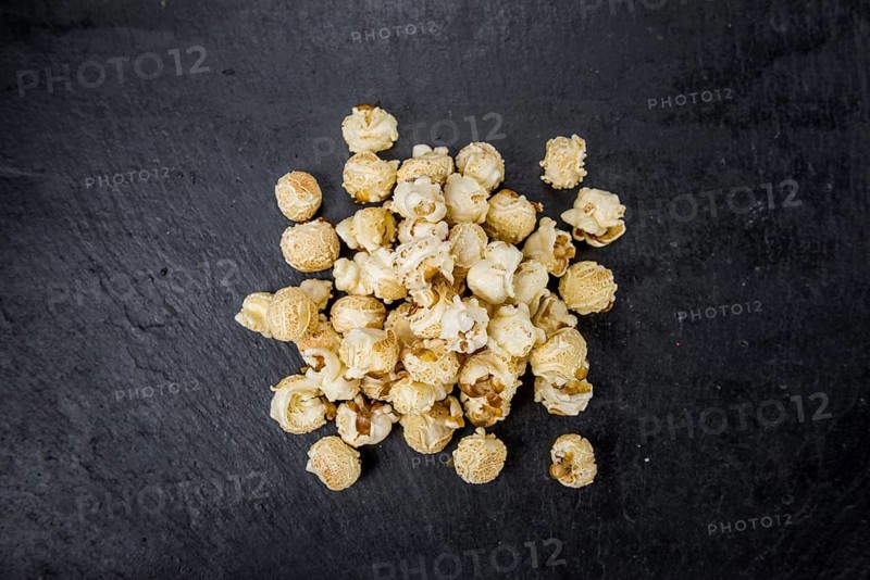Some Popcorn on a slate slab as detailed close-up shot, selective focus