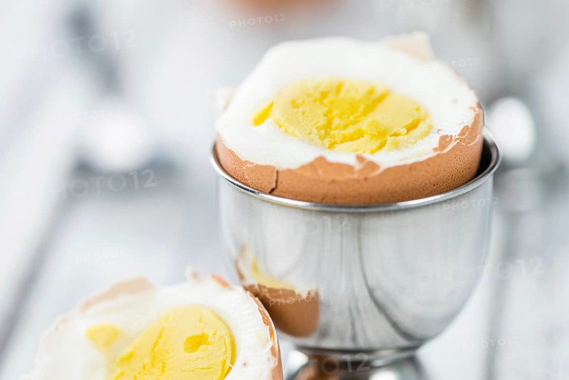 Some boiled Eggs (close-up shot, selective focus) on an old wooden table